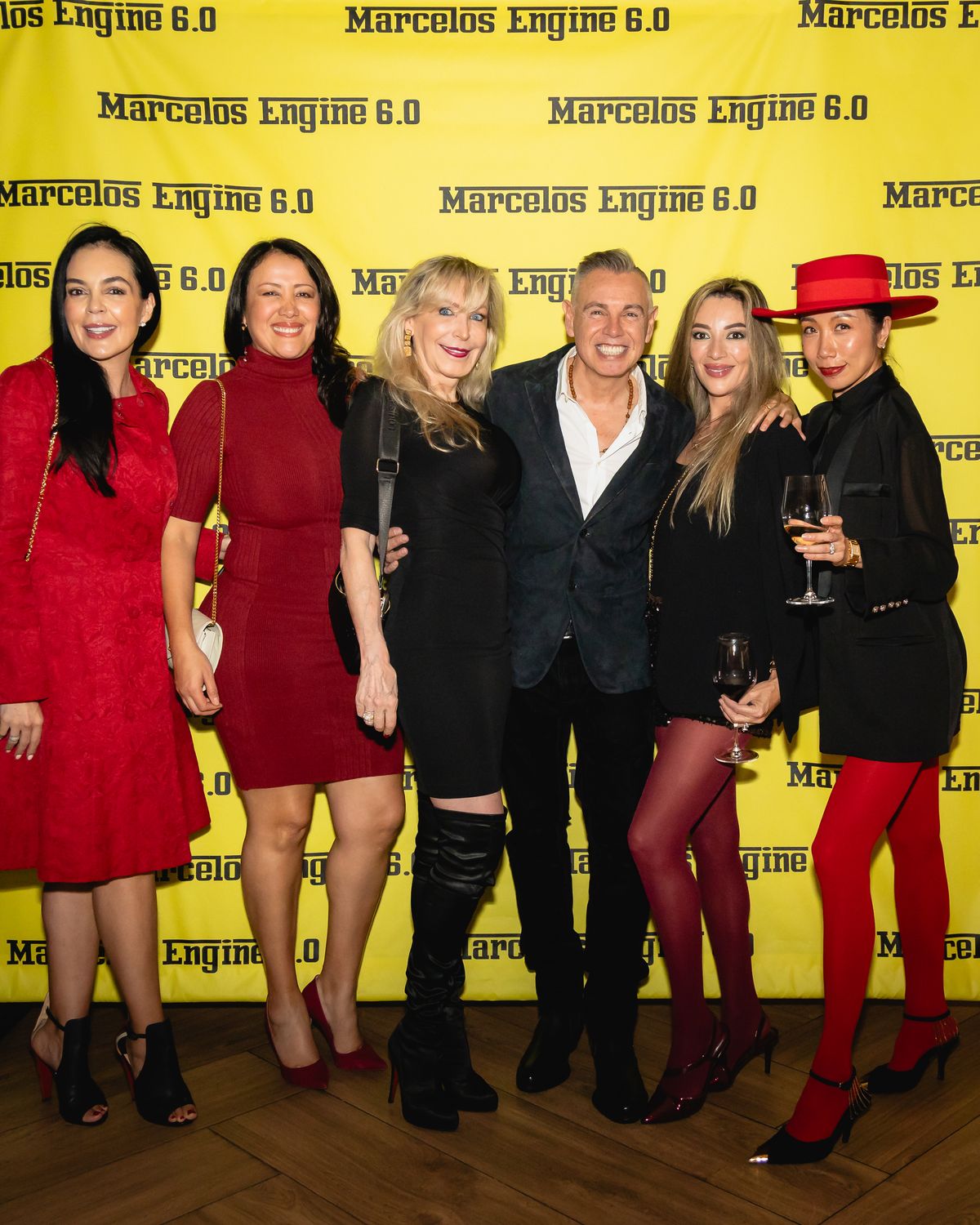 Step-and-repeat group photo at a Miami event